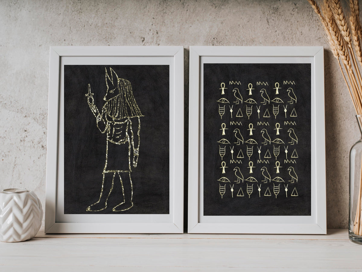 Ancient Egyptian wall art, set of two, black and gold, Anubis, art print displayed in frames.